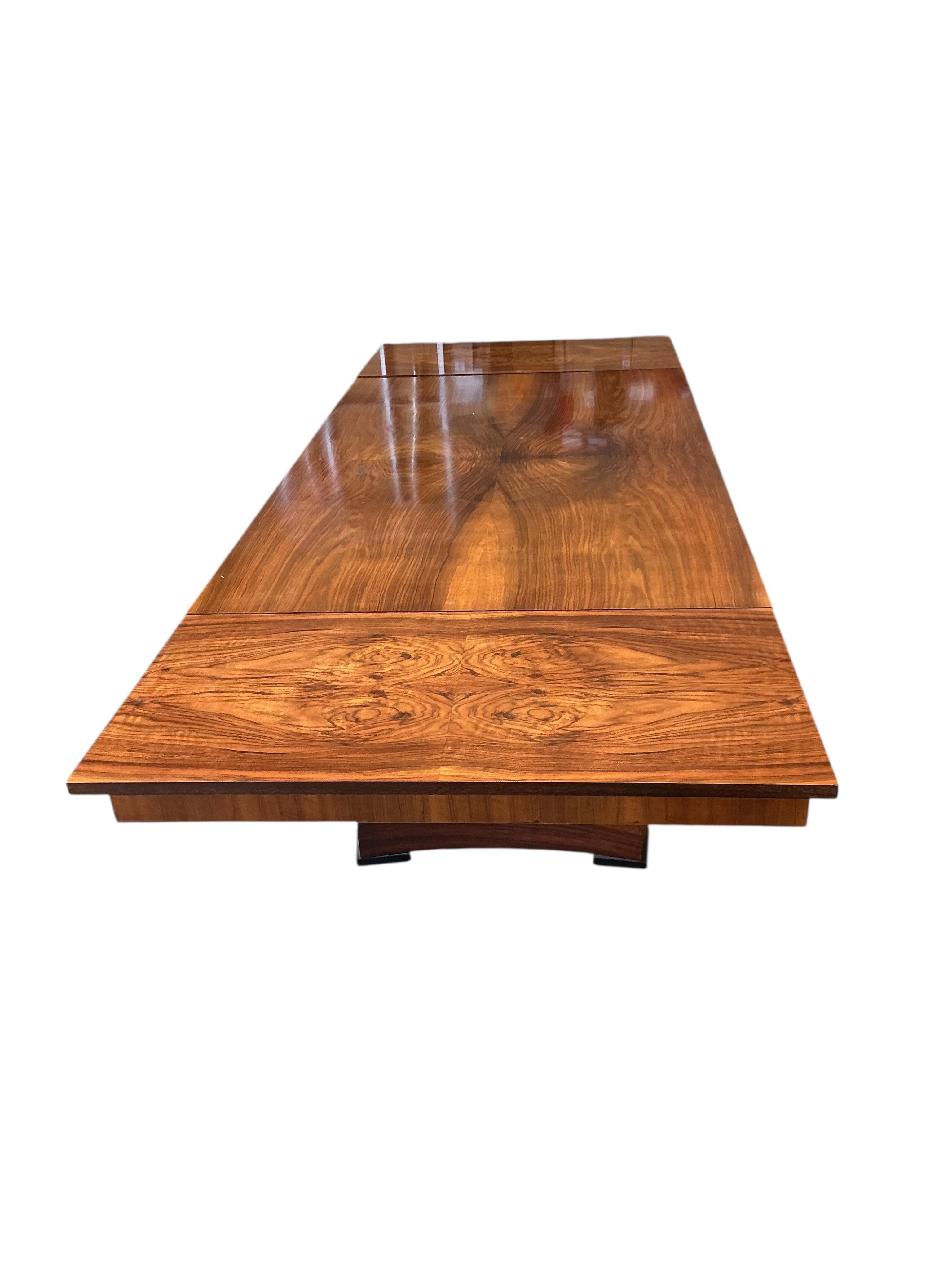 An Art Deco style rectangular walnut dining table, width 254cm extended, two spare leaves, depth 98cm, height 77cm together with six Empire style cherry dining chairs